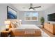 The spacious modern bedroom features lots of light, neutral decor, and hardwood floors at 5200 Dove Dr, New Port Richey, FL 34652