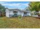 Charming single-story home featuring a well-maintained lawn and welcoming front entrance at 5200 Dove Dr, New Port Richey, FL 34652
