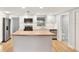Bright kitchen features a butcher block island and stainless steel appliances at 5200 Dove Dr, New Port Richey, FL 34652