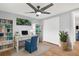 Bright home office features a ceiling fan, a large desk, built-in bookshelves, and plenty of storage at 5200 Dove Dr, New Port Richey, FL 34652