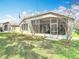 The backyard features a spacious screened lanai with mature trees offering lots of privacy at 5351 Lookout Pass, Wesley Chapel, FL 33544