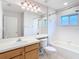 Bright bathroom with a single sink, large mirror, and a shower-tub combination at 5351 Lookout Pass, Wesley Chapel, FL 33544