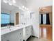 Bright bathroom featuring double sinks, white vanities, a large mirror, and recessed lighting at 5351 Lookout Pass, Wesley Chapel, FL 33544