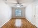 A bright bedroom has a large window and wood floors, creating a comfortable and inviting atmosphere at 5351 Lookout Pass, Wesley Chapel, FL 33544