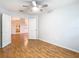 Bright bedroom features hardwood floors, a ceiling fan, and white walls for a clean aesthetic at 5351 Lookout Pass, Wesley Chapel, FL 33544
