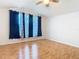 Bedroom with hardwood floors, a ceiling fan, and windows with blackout curtains at 5351 Lookout Pass, Wesley Chapel, FL 33544