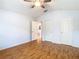 Light and airy bedroom with ceiling fan, hardwood floors and ensuite bathroom access at 5351 Lookout Pass, Wesley Chapel, FL 33544