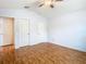 A bright bedroom featuring wood-look floors, and multiple closets and doors at 5351 Lookout Pass, Wesley Chapel, FL 33544