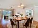 Dining room with wood table set, decorative chandelier, and sliding glass doors at 5351 Lookout Pass, Wesley Chapel, FL 33544