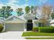 Charming one-story home boasts a two-car garage, manicured lawn, and inviting entrance at 5351 Lookout Pass, Wesley Chapel, FL 33544