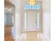 Inviting front foyer with a white door, decorative transom, and tile flooring at 5351 Lookout Pass, Wesley Chapel, FL 33544