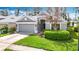 Charming single-story home with a two-car garage, well-maintained lawn, and manicured landscaping at 5351 Lookout Pass, Wesley Chapel, FL 33544