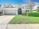 Charming single-Gathering home showcasing a manicured lawn and a two car garage at 5351 Lookout Pass, Wesley Chapel, FL 33544