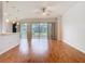 Open-concept living room with hardwood floors and sliding glass door access to patio at 5351 Lookout Pass, Wesley Chapel, FL 33544