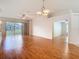 Bright living room featuring hardwood floors, modern lighting, and sliding glass doors at 5351 Lookout Pass, Wesley Chapel, FL 33544