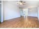 Spacious living room with gleaming wood floors, white walls, a ceiling fan, and neutral decor at 5351 Lookout Pass, Wesley Chapel, FL 33544