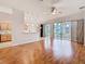Open-concept living room with hardwood floors and sliding glass door access to patio at 5351 Lookout Pass, Wesley Chapel, FL 33544