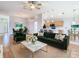 Open-concept living room flows to dining area and kitchen with hardwood floors and modern finishes at 5351 Lookout Pass, Wesley Chapel, FL 33544