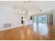 Spacious living room with hardwood floors, ceiling fan, and sliding doors to the outside at 5351 Lookout Pass, Wesley Chapel, FL 33544