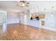 Open concept living area featuring hardwood floors that lead into the kitchen at 5351 Lookout Pass, Wesley Chapel, FL 33544