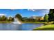Scenic view of a pond with a fountain and rainbow, offering a picturesque and serene community amenity at 5351 Lookout Pass, Wesley Chapel, FL 33544