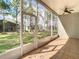 Screened-in porch with tile flooring and a ceiling fan providing a view of the backyard at 5351 Lookout Pass, Wesley Chapel, FL 33544