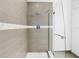 Walk-in shower featuring elegant tile work and a glass door at 5351 Lookout Pass, Wesley Chapel, FL 33544