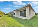 Backyard features a covered patio, green grass, and well-maintained landscaping at 5647 Del Coronado Dr, Apollo Beach, FL 33572