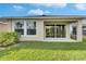 Backyard features a covered patio, green grass, and well-maintained landscaping at 5647 Del Coronado Dr, Apollo Beach, FL 33572