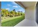 Beautiful backyard with tropical landscaping, a green lawn, and an inviting patio at 5647 Del Coronado Dr, Apollo Beach, FL 33572