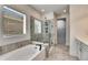 Bathroom featuring a large soaking tub, glass enclosed shower, and tile floors at 5647 Del Coronado Dr, Apollo Beach, FL 33572