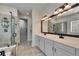 Bathroom features dual sinks, large mirror, and a walk-in closet at 5647 Del Coronado Dr, Apollo Beach, FL 33572