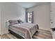 Bedroom with a large window, wood-look floors, and modern door hardware at 5647 Del Coronado Dr, Apollo Beach, FL 33572