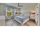 Cozy bedroom with two windows, two night stands, and a ceiling fan at 5647 Del Coronado Dr, Apollo Beach, FL 33572