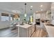 Bright kitchen with stainless steel appliances, a large island with bar seating and an adjacent breakfast nook at 5647 Del Coronado Dr, Apollo Beach, FL 33572