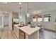 Bright kitchen with stainless steel appliances, an island with bar, and adjacent breakfast nook with a view at 5647 Del Coronado Dr, Apollo Beach, FL 33572