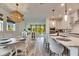 Open-concept kitchen with a large island, stainless steel appliances, and an adjacent dining area at 5647 Del Coronado Dr, Apollo Beach, FL 33572
