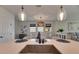 Bright kitchen with modern countertops and an island bar with a sink and decorative pendant lighting at 5647 Del Coronado Dr, Apollo Beach, FL 33572