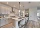 Modern kitchen with stainless steel appliances, a range hood, and an island with bar seating at 5647 Del Coronado Dr, Apollo Beach, FL 33572