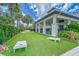 Lawn game area with cornhole boards, bench seating and manicured landscaping at community clubhouse at 5647 Del Coronado Dr, Apollo Beach, FL 33572