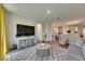 Open concept living room with modern furnishings and an adjacent kitchen space at 5647 Del Coronado Dr, Apollo Beach, FL 33572