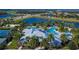 Aerial shot of community clubhouse with a pool and deck surrounded by lush landscaping and palm trees at 5647 Del Coronado Dr, Apollo Beach, FL 33572