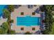 Aerial view of a large community swimming pool with lounge chairs and lush landscaping around the perimeter at 5647 Del Coronado Dr, Apollo Beach, FL 33572