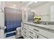 Bathroom with granite countertop vanity and blue patterned shower curtain at 6228 Dutton Dr, Wesley Chapel, FL 33545