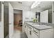 Bathroom featuring a double vanity and views into the bedroom at 6228 Dutton Dr, Wesley Chapel, FL 33545