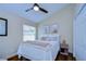 Comfortable bedroom with large window and neutral decor at 6427 Weatherwood Cir, Wesley Chapel, FL 33545