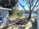 Charming backyard with a fire pit, wooden deck, mature trees, and view of the lake at 6926 Echo Lake Dr, New Port Richey, FL 34653