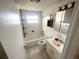 Classic bathroom featuring a tub and shower combo, plus a vanity with storage at 6926 Echo Lake Dr, New Port Richey, FL 34653