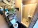 Compact bathroom featuring patterned wall paper, a standing shower, and basic fixtures at 6926 Echo Lake Dr, New Port Richey, FL 34653