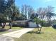 Charming single-story home with a well-maintained front yard, mature trees, and attached garage at 6926 Echo Lake Dr, New Port Richey, FL 34653
